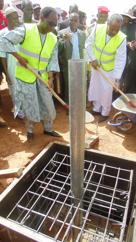 Le ministre Auguste Denise Barry et son homologue nigérien, Massoudou Hassoumi construisant symboliquement la première borne frontière entre les deux Etats. (©Burkina24)